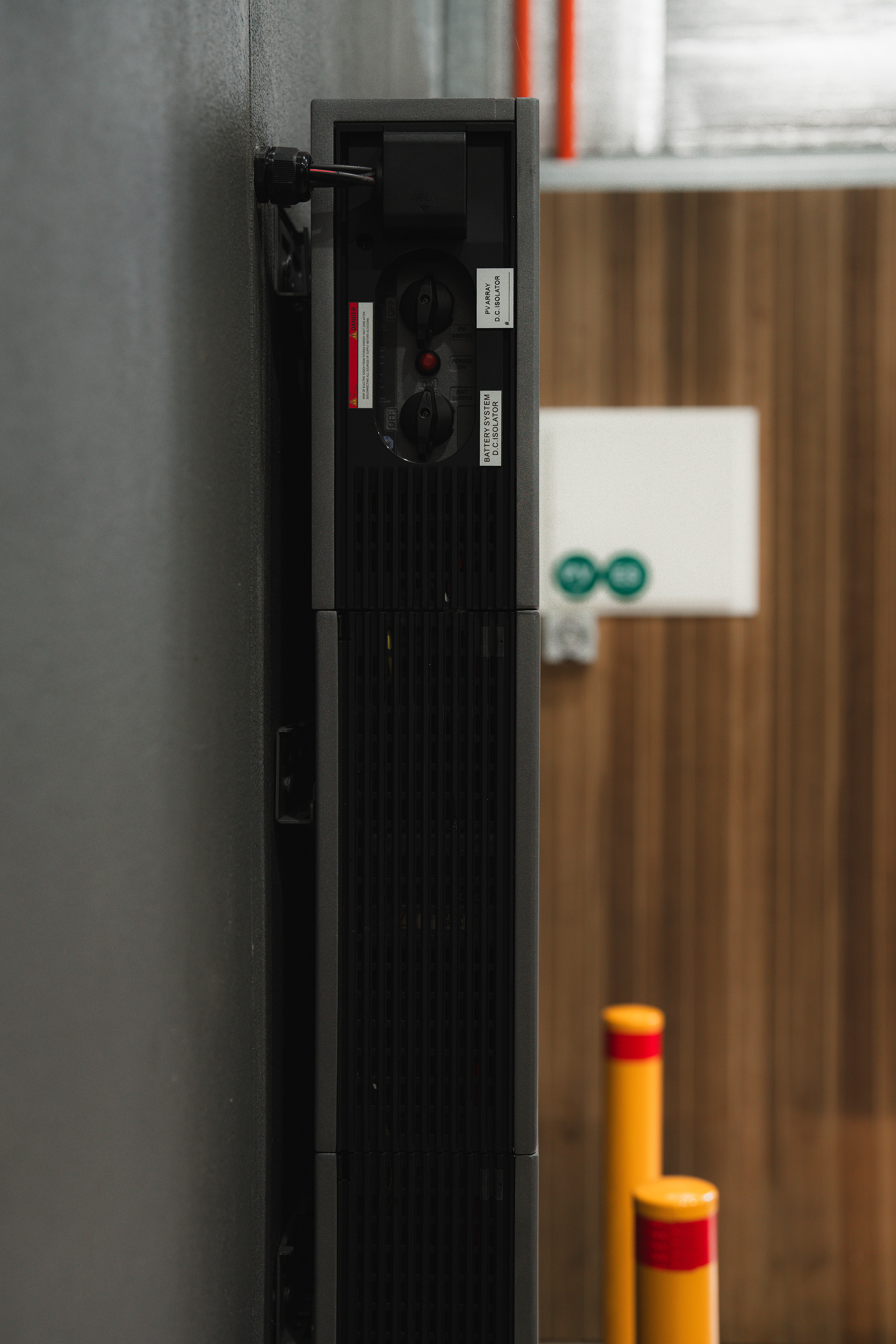 Side view showing the slim profile of an Anker SOLIX X1 home battery stack installed against the shed wall.